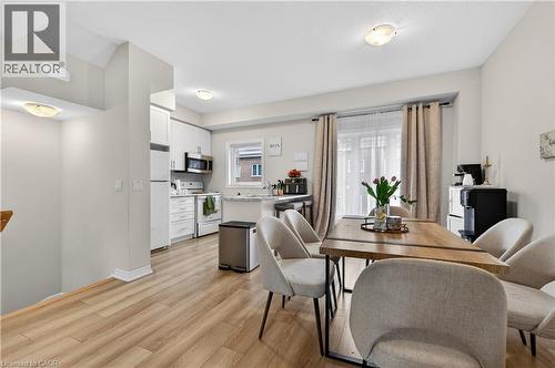 Kitchen with white cabinetry, stainless steel appliances, and a window with a white frame - 19 Picardy Drive Unit# 13, Hamilton, ON - Indoor Photo Showing Dining Room