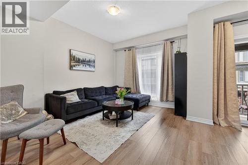 Wood-finish flooring, recessed ceiling light, and multiple windows with drapery rods - 19 Picardy Drive Unit# 13, Hamilton, ON - Indoor Photo Showing Living Room