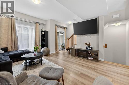 Wood-finish flooring, recessed lighting, and a light-filled interior with large windows - 19 Picardy Drive Unit# 13, Hamilton, ON - Indoor Photo Showing Living Room
