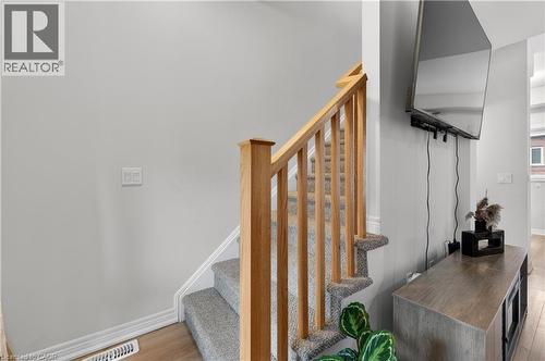 Staircase featuring wood-finish handrail and carpeted treads - 19 Picardy Drive Unit# 13, Hamilton, ON - Indoor Photo Showing Other Room
