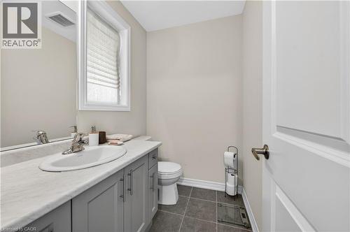 Vanity with light-toned countertop, undermount sink, and chrome faucet - 19 Picardy Drive Unit# 13, Hamilton, ON - Indoor Photo Showing Bathroom