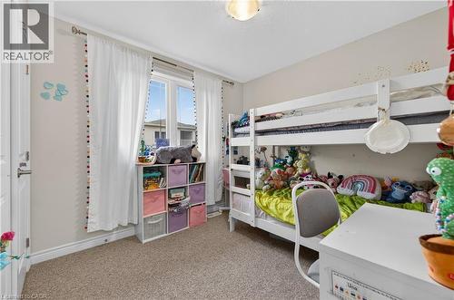 Neutral wall color, carpet flooring, a window with natural light, and a built-in overhead light fixture - 19 Picardy Drive Unit# 13, Hamilton, ON - Indoor