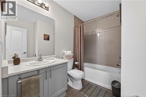 Vanity with gray cabinetry, integrated sink, and light-toned countertop - 19 Picardy Drive Unit# 13, Hamilton, ON - Indoor Photo Showing Bathroom