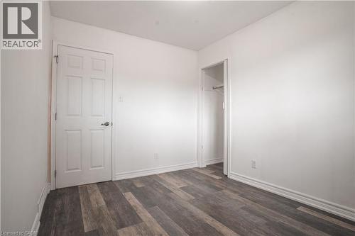 Bright, neutral bedroom featuring hardwood-finish flooring, clean white walls, and ample natural light - 695 Glen Forrest Boulevard Unit# Upper, Waterloo, ON - Indoor Photo Showing Other Room