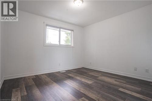 Bright, light-filled bedroom featuring newly installed wood-finish flooring, clean white walls, and a recessed ceiling light - 695 Glen Forrest Boulevard Unit# Upper, Waterloo, ON - Indoor Photo Showing Other Room