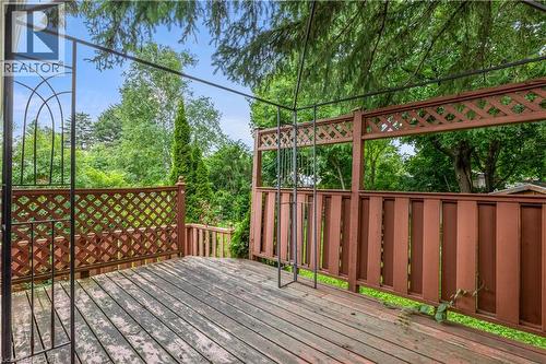 Spacious composite deck featuring wood-finish flooring, decorative lattice railings with geometric patterns, and integrated arbor archway - 695 Glen Forrest Boulevard Unit# Upper, Waterloo, ON - Outdoor