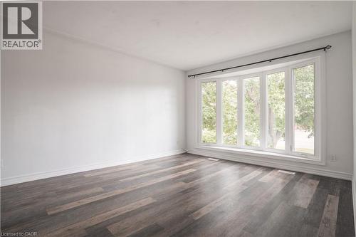 Bay window with white trim, wood-finish flooring, white baseboards, and white wall finishes - 695 Glen Forrest Boulevard Unit# Upper, Waterloo, ON - Indoor Photo Showing Other Room