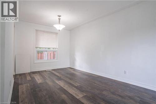 Wood-finish flooring, white walls, and a single window with a roller shade - 695 Glen Forrest Boulevard Unit# Upper, Waterloo, ON - Indoor Photo Showing Other Room