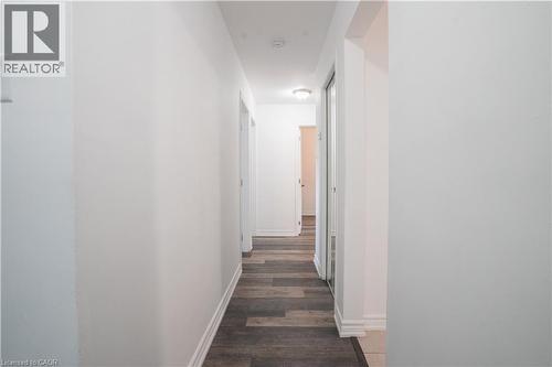 Bright hallway with clean white walls, dark wood-finish flooring, and recessed ceiling lighting - 695 Glen Forrest Boulevard Unit# Upper, Waterloo, ON - Indoor Photo Showing Other Room
