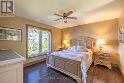 PRIMARY BEDROOM WITH A VIEW OF THE LAKE - 