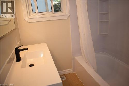 White vanity with an integrated sink and matte black faucet - 655 Albert Street Unit# A, Waterloo, ON - Indoor Photo Showing Bathroom