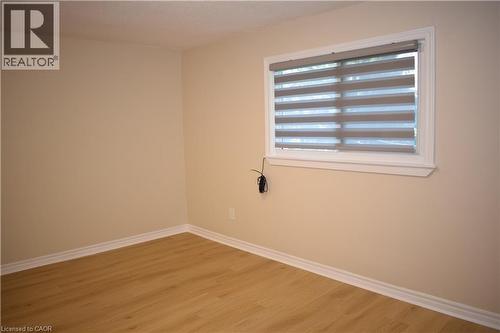 Light-toned walls, wood-finish flooring, white window trim, and white baseboards - 655 Albert Street Unit# A, Waterloo, ON - Indoor Photo Showing Other Room