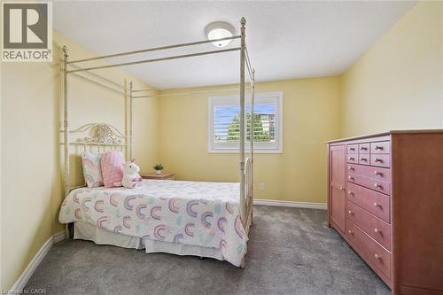 Carpeted room featuring a single window with white shutters, a flush-mount ceiling light, and light-colored walls - 60 Elmsdale Drive Unit# 25, Kitchener, ON - Indoor Photo Showing Bedroom