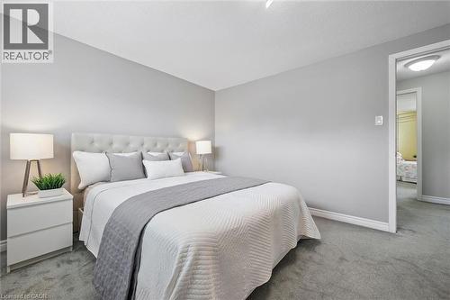 Wall-to-wall carpeting, light gray wall paint, and white trim - 60 Elmsdale Drive Unit# 25, Kitchener, ON - Indoor Photo Showing Bedroom