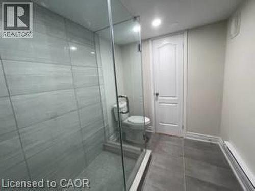 Walk-in shower with full glass enclosure, large format wall tile, and recessed ceiling lighting - 15 Pinecrest Drive Unit# Lower, Kitchener, ON - Indoor Photo Showing Bathroom