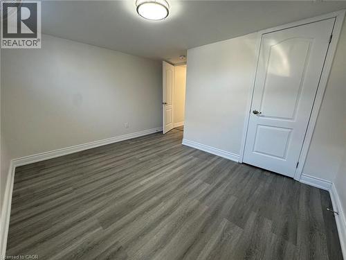 Spacious bedroom offering neutral walls, wood-finish plank flooring, and abundant natural light - 15 Pinecrest Drive Unit# Lower, Kitchener, ON - Indoor Photo Showing Other Room