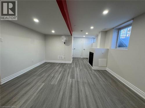 Recessed lighting, wood-finish flooring, white trim, built-in fireplace, and white paneled doors - 15 Pinecrest Drive Unit# Lower, Kitchener, ON - Indoor