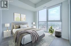 Floor-to-ceiling windows, wood-finish flooring, recessed ceiling, and light-toned walls - 
