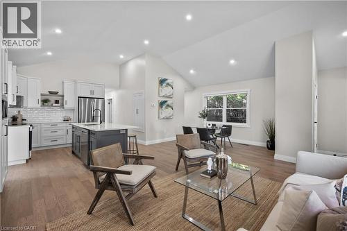 Open-concept living and kitchen space with vaulted ceilings, recessed lighting, and abundant natural light from large windows - 1041 Shepherd'S Drive, Burlington, ON - Indoor