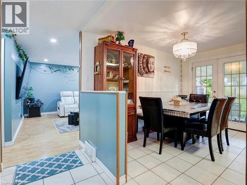 Dining area with tile flooring and a decorative chandelier - 128 Macatee Place, Cambridge, ON - Indoor Photo Showing Dining Room