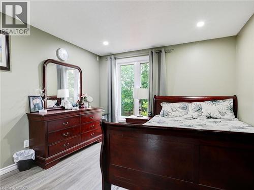 Recessed lighting, wood-finish flooring, and a large sliding glass door - 128 Macatee Place, Cambridge, ON - Indoor Photo Showing Bedroom