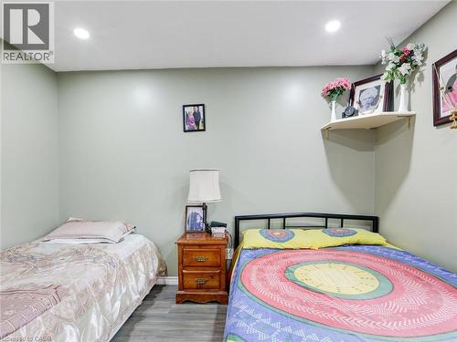 Recessed ceiling lighting, light grey walls, wood-finish flooring, and a corner-mounted shelf - 128 Macatee Place, Cambridge, ON - Indoor Photo Showing Bedroom