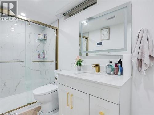 White vanity with gold-tone hardware, rectangular undermount sink, and quartz countertop - 128 Macatee Place, Cambridge, ON - Indoor Photo Showing Bathroom