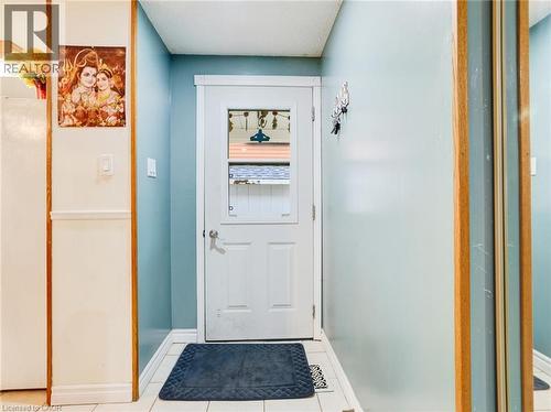 White door with clear glass panels, tile flooring, and light blue wall paint - 128 Macatee Place, Cambridge, ON - Indoor Photo Showing Other Room