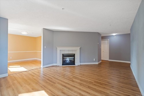 #302-9975 Fifth St, Sidney, BC - Indoor Photo Showing Living Room With Fireplace