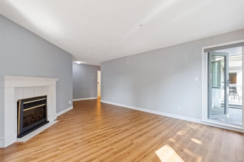 #302-9975 Fifth St, Sidney, BC - Indoor Photo Showing Other Room With Fireplace