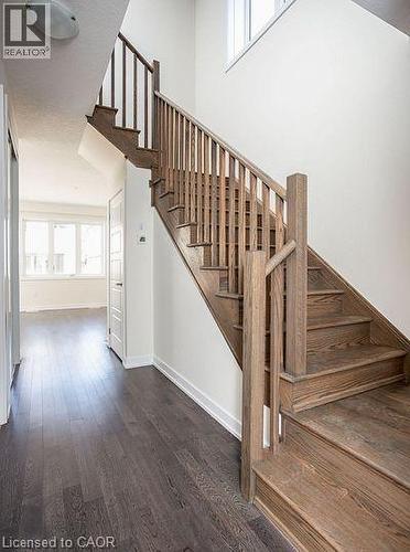 Solid wood staircase with natural finish - 16 Monteith Drive, Brantford, ON - Indoor Photo Showing Other Room