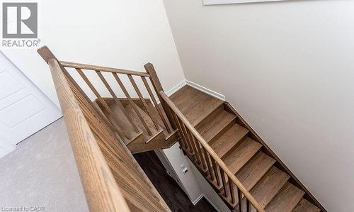 Staircase featuring wood-finish treads and risers, with a coordinating wood-finish handrail and balusters - 16 Monteith Drive, Brantford, ON - Indoor Photo Showing Other Room
