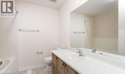 White tile flooring and bathtub surround - 16 Monteith Drive, Brantford, ON - Indoor Photo Showing Bathroom
