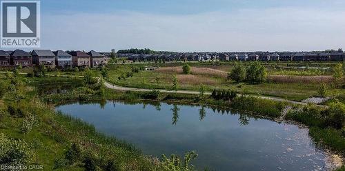 Expansive community featuring multiple residential properties, a large pond, and extensive green spaces with walking paths - 16 Monteith Drive, Brantford, ON - Outdoor With Body Of Water With View