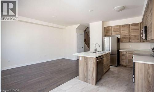 Spacious open-concept layout with wood-finish flooring - 16 Monteith Drive, Brantford, ON - Indoor Photo Showing Kitchen
