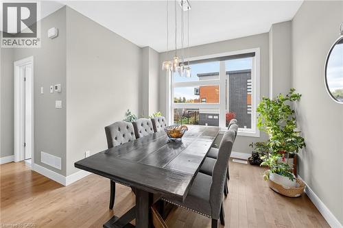 Hardwood-finish flooring, recessed lighting, and a large window with white trim - 60 Arkell Road Unit# 57, Guelph, ON - Indoor Photo Showing Dining Room