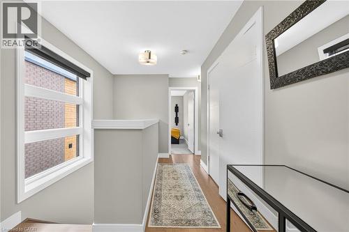 Hardwood-finish flooring, white paneled doors with chrome hardware, and a semi-flush mount ceiling light fixture - 60 Arkell Road Unit# 57, Guelph, ON - Indoor Photo Showing Other Room