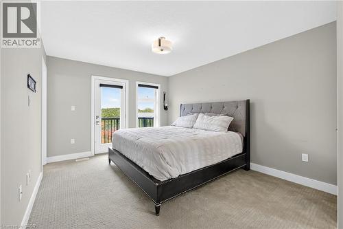 Wall-to-wall carpeting, light gray wall paint, and white trim - 60 Arkell Road Unit# 57, Guelph, ON - Indoor Photo Showing Bedroom