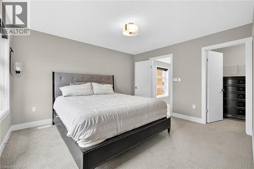 Neutral wall paint, light-toned carpet flooring, recessed lighting, ceiling-mounted light fixture, white trim - 60 Arkell Road Unit# 57, Guelph, ON - Indoor Photo Showing Bedroom