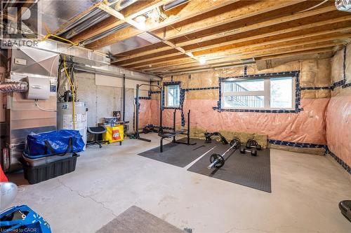 Unfinished lower level with exposed ceiling joists, concrete flooring, and multiple light fixtures - 60 Arkell Road Unit# 57, Guelph, ON - Indoor Photo Showing Basement