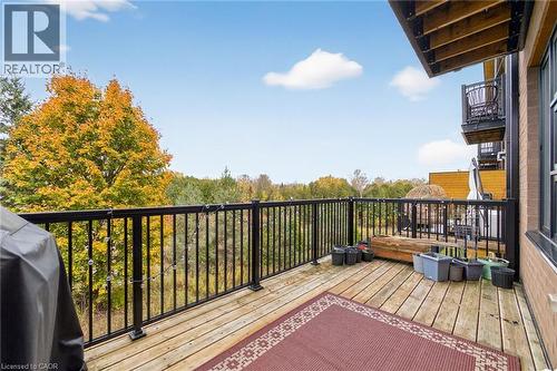 Wood-finish decking with black metal railings - 60 Arkell Road Unit# 57, Guelph, ON - Outdoor With Balcony With Exterior