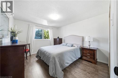 Wood-finish flooring, white walls, and a window with a white frame - 230 Sunset Boulevard, Cambridge, ON - Indoor Photo Showing Bedroom