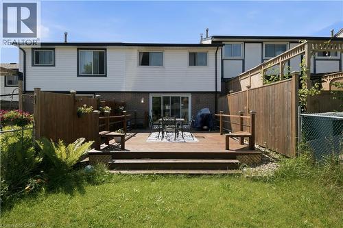 Expansive wood-finish deck with privacy fencing, offering direct access to the interior via a sliding glass door - 230 Sunset Boulevard, Cambridge, ON - Outdoor With Exterior