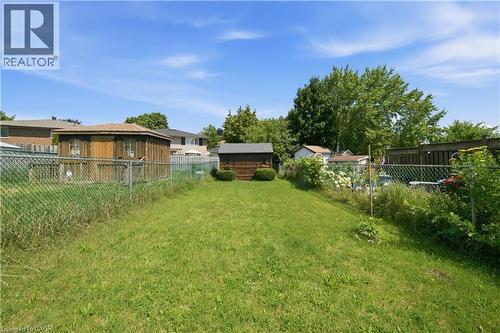 Expansive grassy yard area featuring a chain-link fence and a small detached shed - 230 Sunset Boulevard, Cambridge, ON - Outdoor