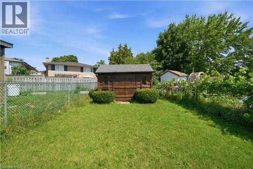 Expansive grassy yard area featuring a storage shed and chain-link fencing - 230 Sunset Boulevard, Cambridge, ON - Outdoor