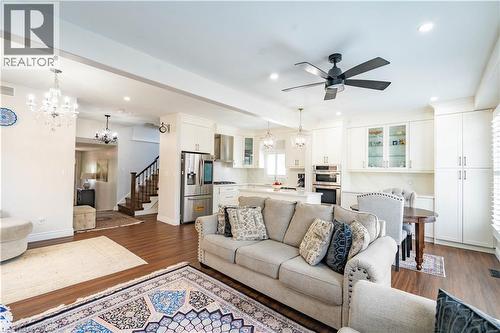 Open-concept living space with dark wood-finish flooring, recessed lighting, and a modern ceiling fan - 122 Iron Gate Street, Kitchener, ON - Indoor Photo Showing Living Room