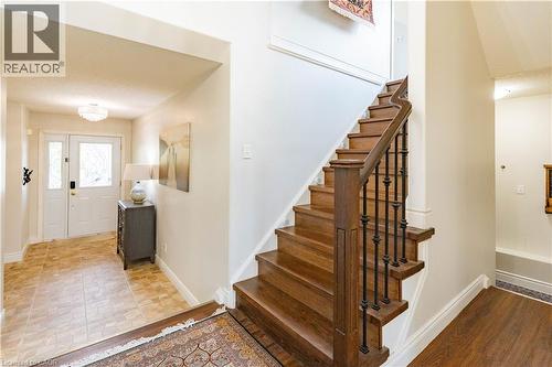 Wood staircase with wrought iron balusters - 122 Iron Gate Street, Kitchener, ON - Indoor Photo Showing Other Room