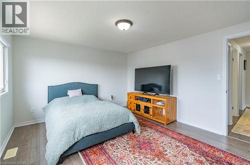 Recessed lighting, wood-finish flooring, and white walls - 122 Iron Gate Street, Kitchener, ON - Indoor Photo Showing Bedroom