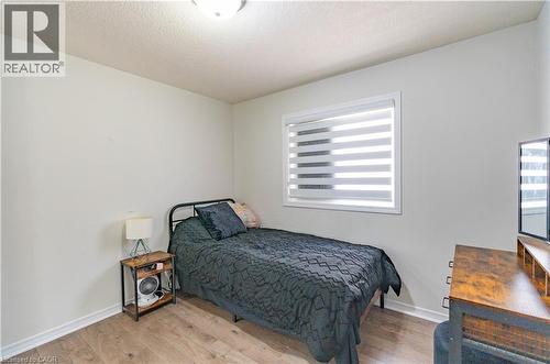 Wood-finish flooring with white walls - 122 Iron Gate Street, Kitchener, ON - Indoor Photo Showing Bedroom