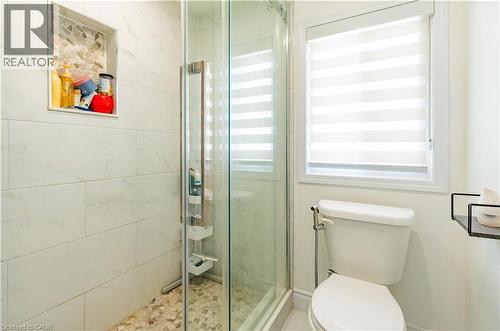 Glass-enclosed shower with subway tile surround and mosaic-tiled shower niche - 122 Iron Gate Street, Kitchener, ON - Indoor Photo Showing Bathroom